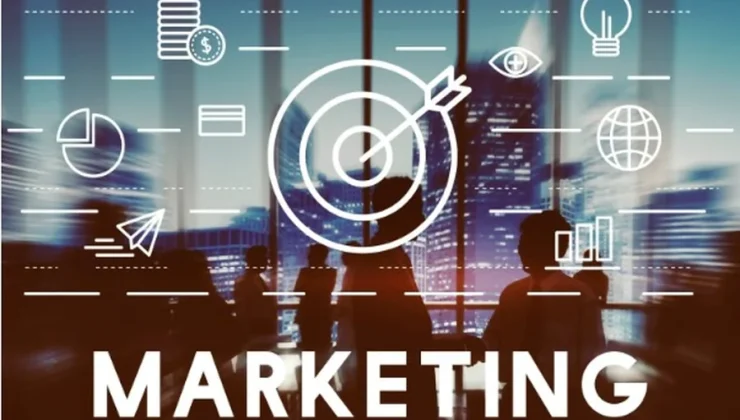Marketing concept with target icon and analytics graphics displayed over a team meeting in a city office